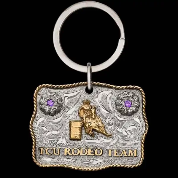 "Our Longest Ride Custom Keychain is a mini buckle designed with the same craftsmanship as our signature buckles. Crafted on a hand-engraved German Silver base, it features two flowers in the top corners, accented with cubic zirconia stones. The desi